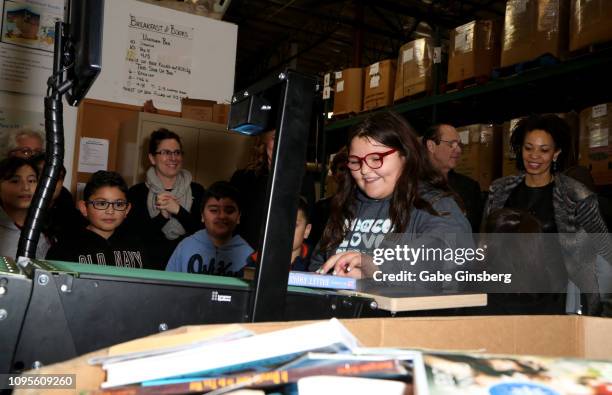 Ronnow Elementary School students take turns using a book sorting machine at Spread the Word Nevada on January 17, 2019 in Henderson, Nevada.