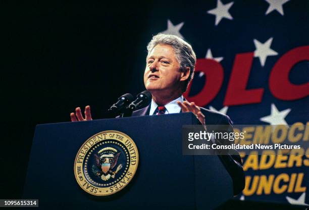American politician US President Bill Clinton speaks from a podium at the Democratic Leadership Council's 1995 Annual Conference in the Washington...