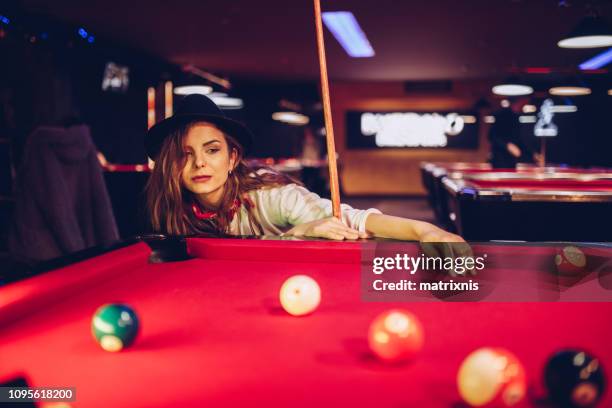 young sensual female playing pool - woman shooting pool stock pictures, royalty-free photos & images