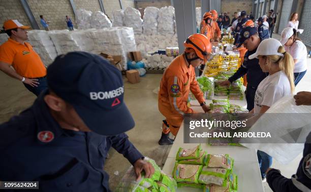 Volunteers, firefighters and civil defense officers arrange US humanitarian aid goods in Cucuta, Colombia, on the border with Tachira, Venezuela, on...