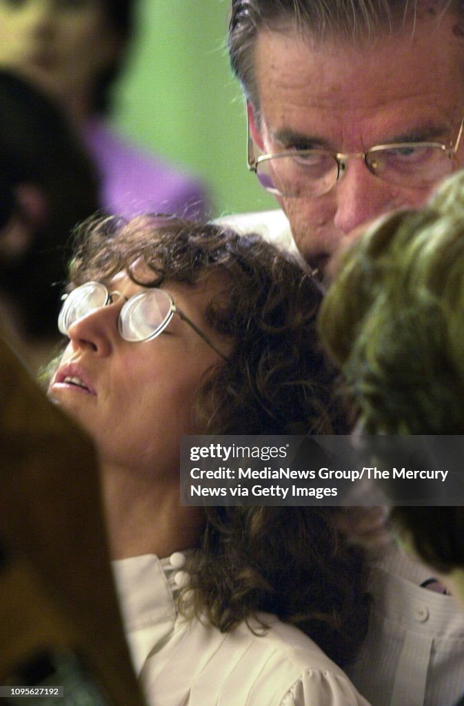 George Helzer Carma Helzer leans against her husband Gerry for support during a ...
