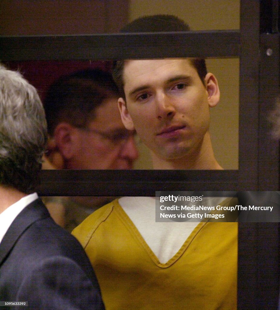 George Helzer Justin Helzer stands behind bars during a hearing in Superior Court ...