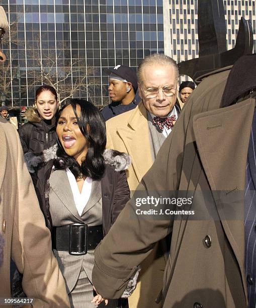 Rap star Lil' Kim, whose real name is Kimberly Jones, flanked by her legal team and fans, enters Manhattan federal court, Monday, March 14 in New...