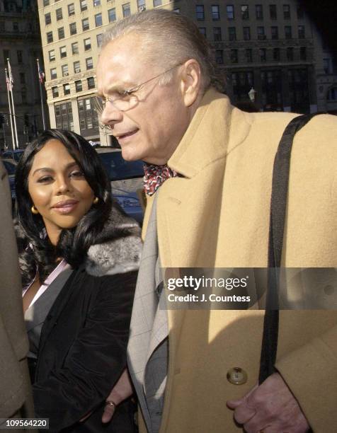 Rap star Lil' Kim, whose real name is Kimberly Jones, flanked by her legal team and fans, enters Manhattan federal court, Monday, March 14 in New...