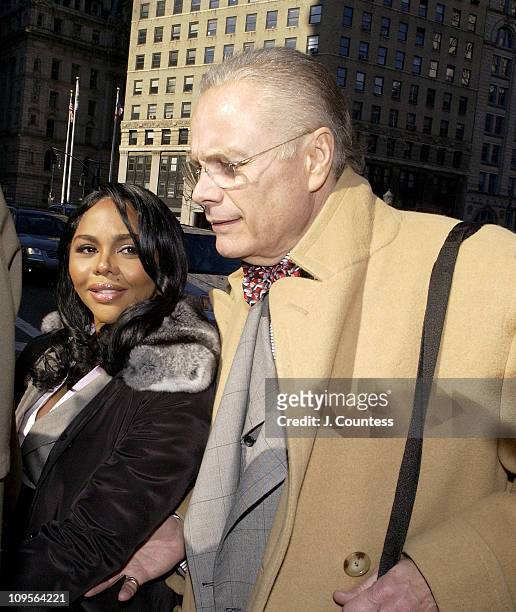 Rap star Lil' Kim, whose real name is Kimberly Jones, flanked by her legal team and fans, enters Manhattan federal court, Monday, March 14 in New...