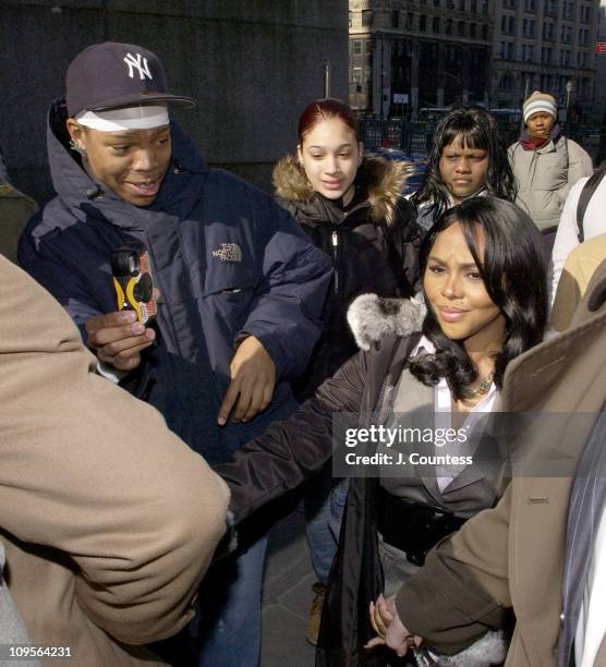 Rap star Lil' Kim, whose real name is Kimberly Jones, flanked by her legal team and fans, enters Manhattan federal court, Monday, March 14 in New...