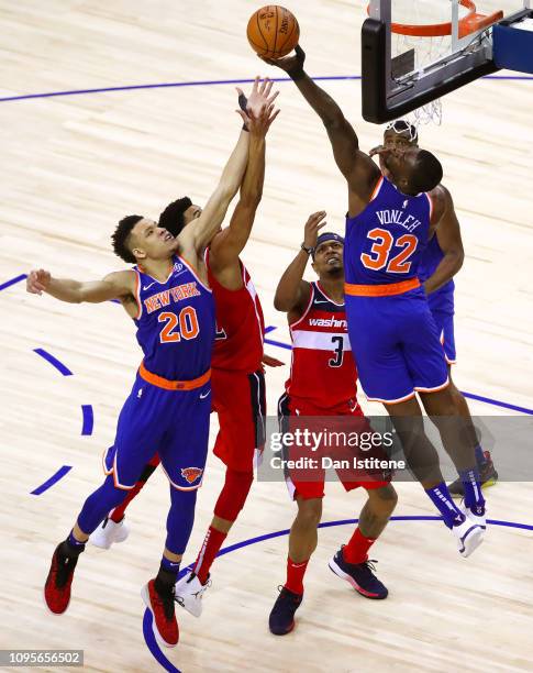 Otto Porter Jr. #22 of the Washington Wizards jumps with Kevin Knox of the New York Knicks and Noah Vonleh of the New York Knicks for a rebound...