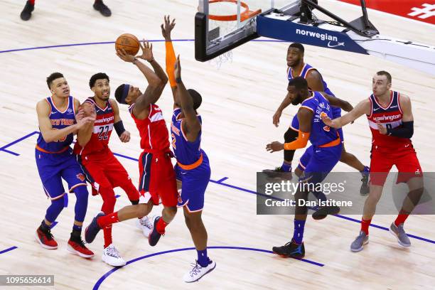 Bradley Beal of the Washington Wizards attempts to shoot under pressure from Noah Vonleh of the New York Knicks during the NBA London Game 2019...