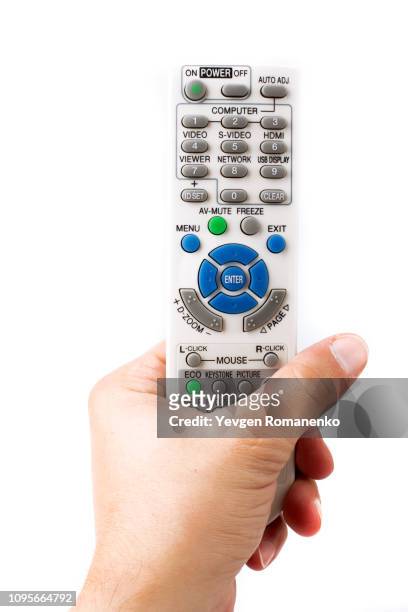 hand holding remote control on white background - remote controlled fotografías e imágenes de stock