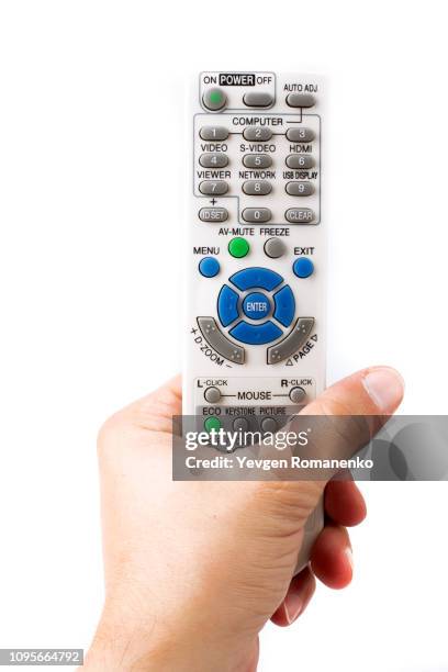 hand holding remote control on white background - remote controlled 個照片及圖片檔