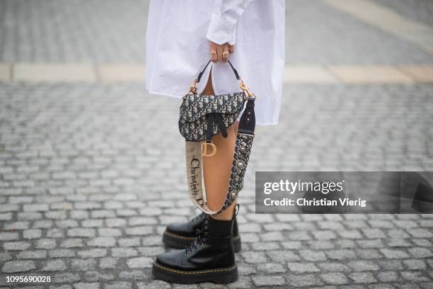 Aylin Koenig is seen wearing white dress Calvin Klein 205W39NYC, Dior saddle bag, Dr Martens boots during the Berlin Fashion Week Autumn/Winter 2019...