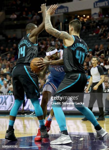 Teammates Willy Hernangomez and Michael Kidd-Gilchrist of the Charlotte Hornets try to stop Willie Cauley-Stein of the Sacramento Kings during their...