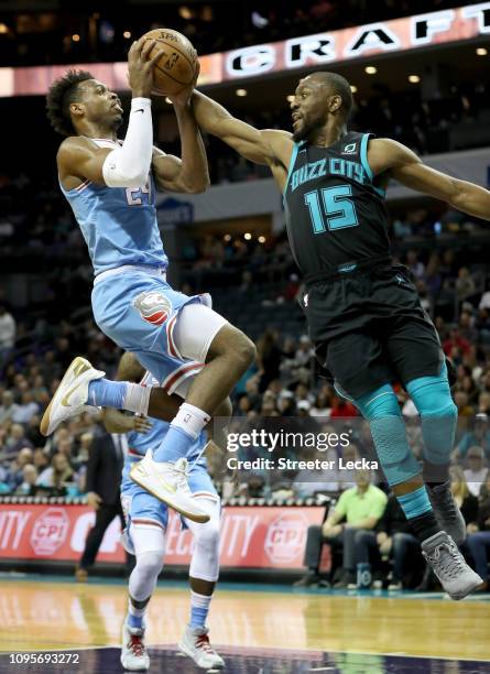 Buddy Hield of the Sacramento Kings drives to the basket against Kemba Walker of the Charlotte Hornets during their game at Spectrum Center on...