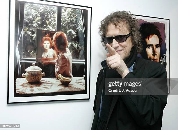 Mick Rock with his portraits of David Bowie and John Lydon