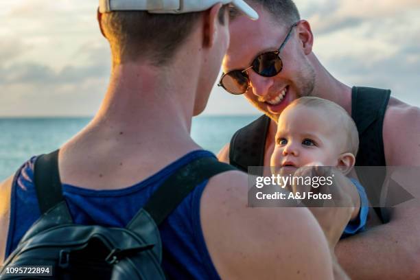 homosexual godparents and their young nephew - godfather stock pictures, royalty-free photos & images