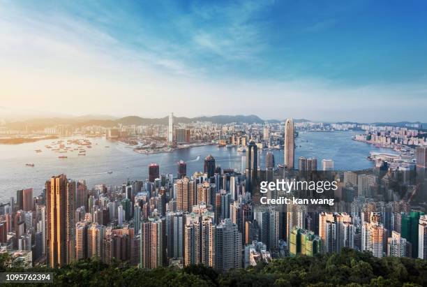 hong kong skyline china - east asia skyscraper cityscape day victoria harbour - hong kong ship sunset futuristic island architecture asia blue city cloud - sky cloudscape development district downtown dusk famous place harbour hong kong island horizontal - hongkong stock pictures, royalty-free photos & images