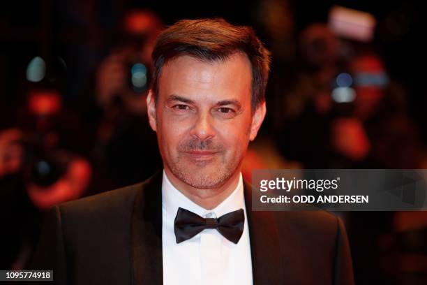 French director Francois Ozon poses for photographers as he arrives on the red carpet for the premiere of the film "Grace a Dieu" during the 69th...