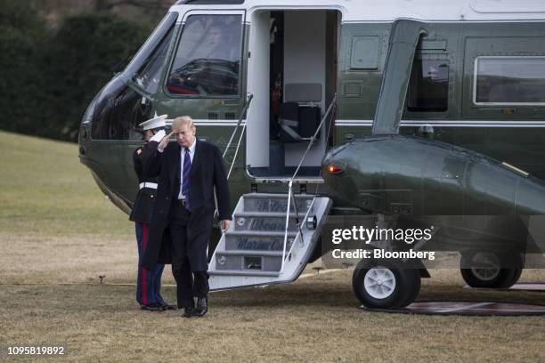 President Donald Trump salutes after arriving on Marine One on the South Lawn of the While House in Washington, D.C., U.S., on Friday, Feb. 8, 2019....