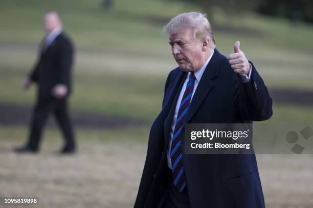 President Donald Trump gives a thumbs up while walking on the South Lawn of the White House after arriving on Marine One in Washington, D.C., U.S.,...