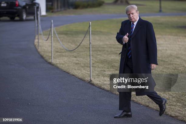 President Donald Trump gives a thumbs up while walking on the South Lawn of the White House after arriving on Marine One in Washington, D.C., U.S.,...