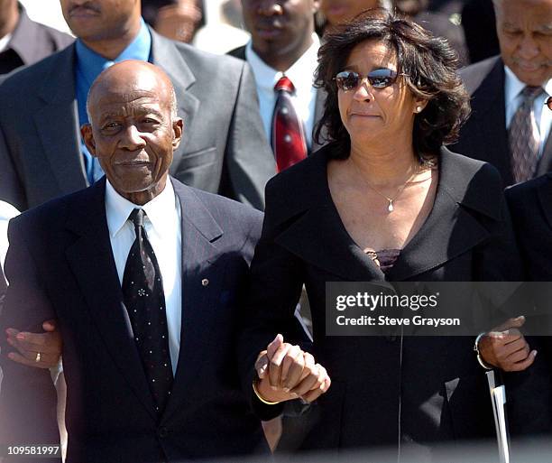 Johnnie L. Cochran Sr., father, and Dale Cochran, wife of the late Johnnie Cochran, leave the West Angeles Cathedral where the funeral service for...