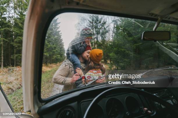 Family with son  near the van in forest