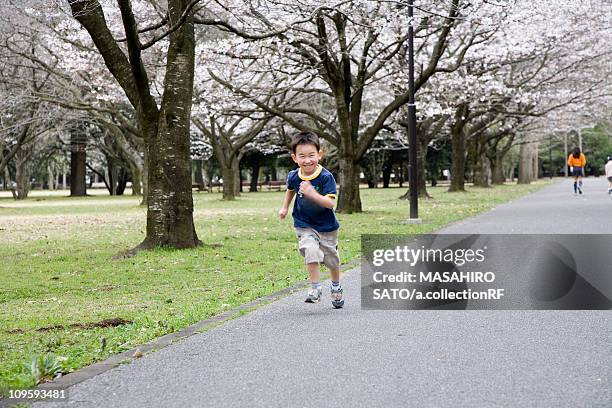 boy running in park - utsunomiya stock pictures, royalty-free photos & images