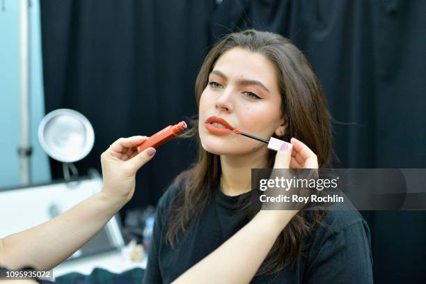 Makeup artist prepares a model with makeup provided by Maybelline New York backstage Gallery I for Cushnie runway show during New York Fashion Week:...