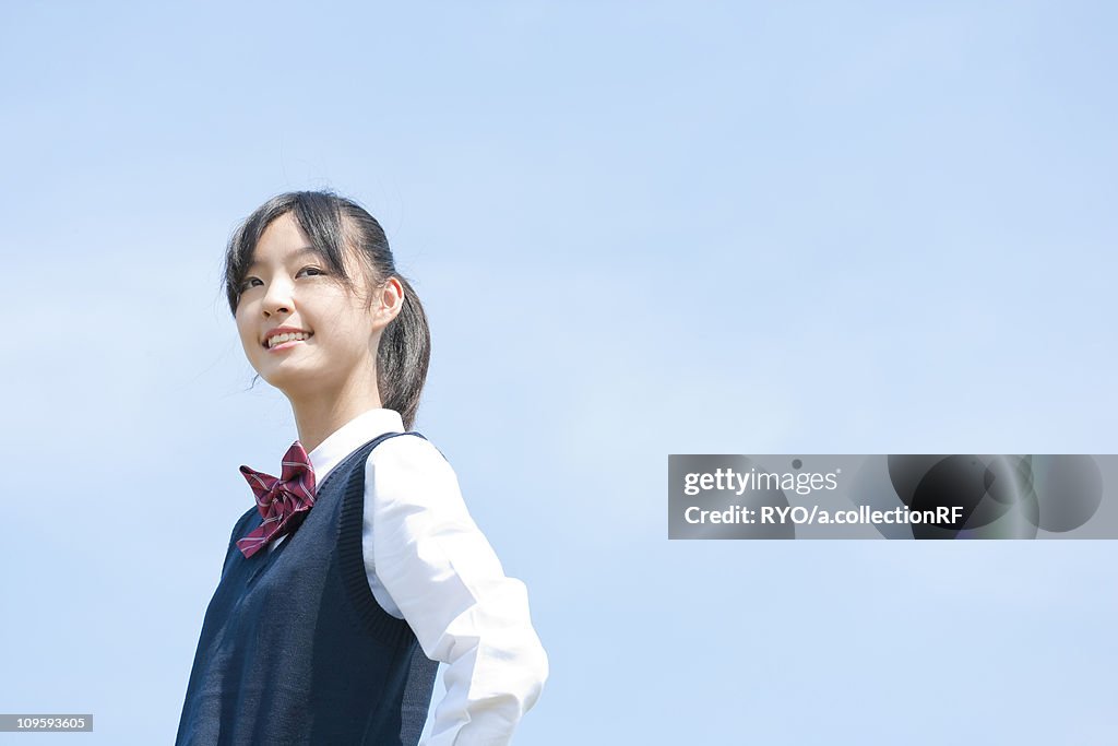 Schoolgirl Against Clear Sky