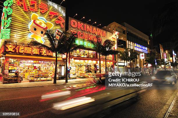 kokusai street at night - okinawa prefecture stock-fotos und bilder