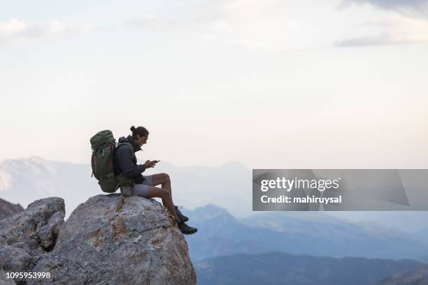 hiker with mobile phone and backpack - backpacker phone stock pictures, royalty-free photos & images