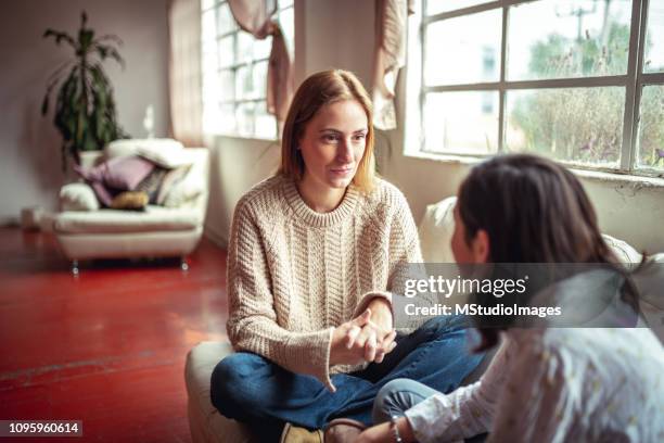 mother and daughter having a talk. - adult family stock pictures, royalty-free photos & images