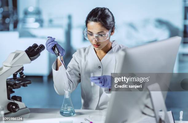 male scientist working in the laboratory - poc engineer stock pictures, royalty-free photos & images