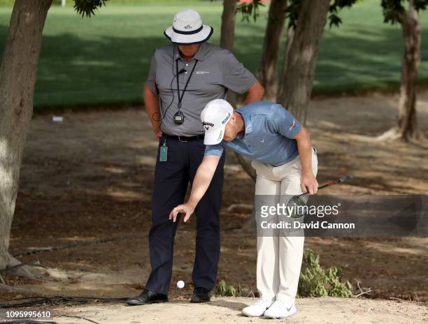 David Horsey of England takes a drop under the new rules of golf by dropping his ball from knee height under the watchful eye of European Tour...