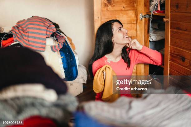 woman sorting out wardrobe - arrangement stock pictures, royalty-free photos & images