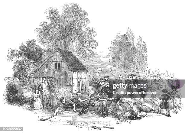 people hurling a the village of hampton lucy in warwickshire, england - hurley stick stock illustrations