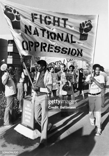 Protesters march outside the University of California Davis Medical School during the first day of classes as Allan Bakke, winner of the historic...