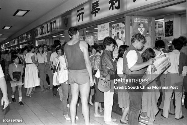 Avid fans queue outside the Tom Lee Music Co's Central branch to buy tickets for the David Bowie concert to be held at the Hong Kong Coliseum. People...