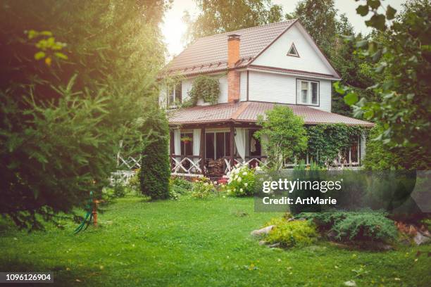 country house with green back yard in sunny summer day - small cottage stock pictures, royalty-free photos & images