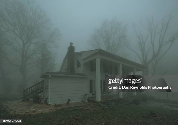 vintage old house in fog - haunted house stock-fotos und bilder