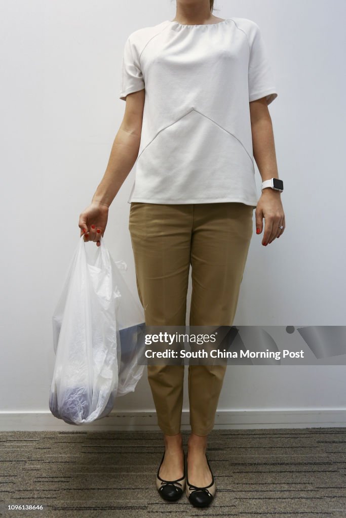 Writer Rachel Jacqueline shows the incorrect way to carry a shopping bags at Prohealth Sports and Spinal at Jardine House in Central. 21MAR16   [LIFE HEALTH]  SCMP/Jonathan Wong