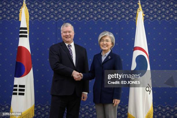 Special Representative for North Korea Stephen Biegun shakes hands with South Korea's Foreign Minister Kang Kyung-wha during their meeting at the...