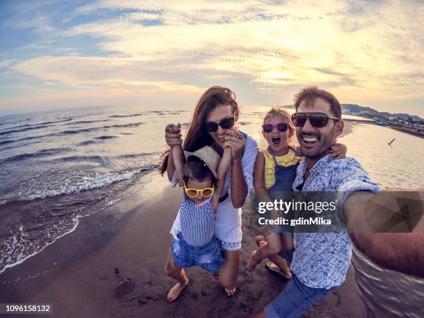 playful family selfie with wide angle camera - family wide angle stock pictures, royalty-free photos & images