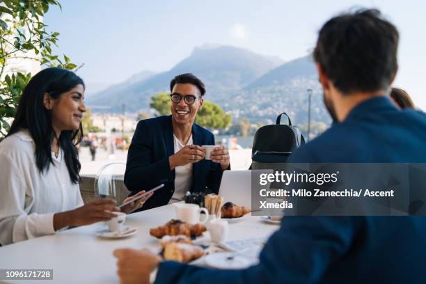 business colleagues meet at outdoor restaurant - indian restaurant stock pictures, royalty-free photos & images