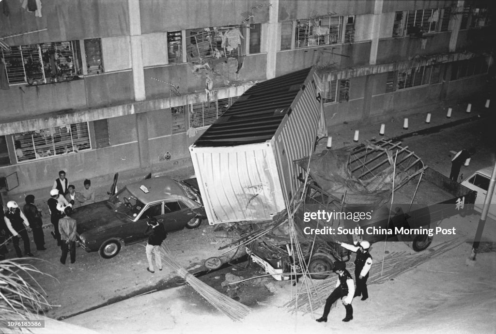 Traffic policemen arrive at an accident site in the So Uk Estate, where a taxi and a container lorry collided. 18DEC77