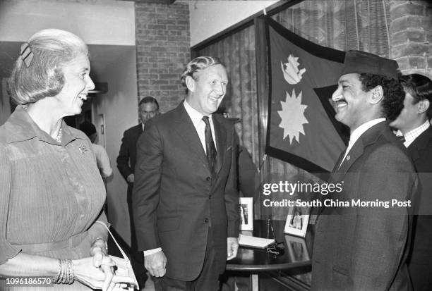 Sir John Archer and Lieut-Colonel P. S. Malla chatting happily after toasting the 33rd birthday of King Birendra Bir Bikram of Nepal. At left is Lady...