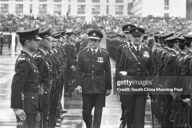 Roger Lobo , Commissioner for Civil Aid Service, inspecting a passing-out parade staged by policemen at the Aberdeen police training school. 31DEC77