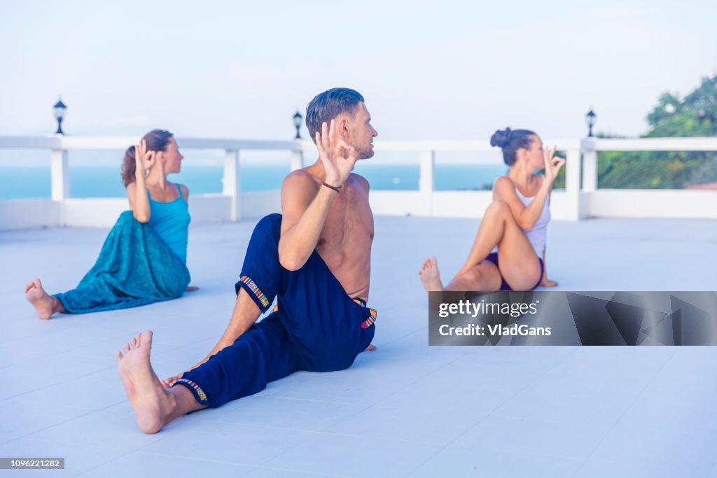 Yoga teacher helping students