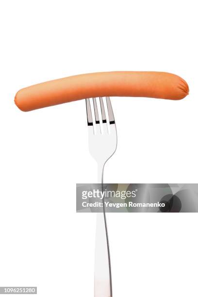 sausage on a shiny reflecting fork - sausage stock pictures, royalty-free photos & images