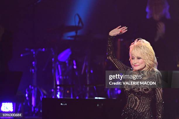 Singer-songwriter and 2019 MusiCares Person Of The Year Dolly Parton waves after performing onstage at the 2019 MusiCares Person Of The Year gala at...